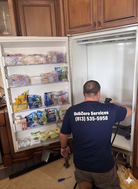 Certified Sub-Zero technician repairing a built-in freezer in Tampa